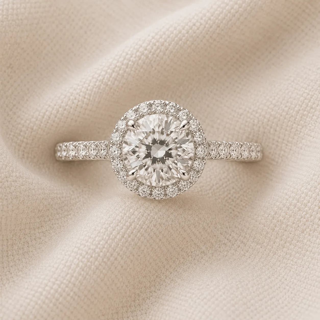 Round brilliant halo engagement ring with pavé diamond halo