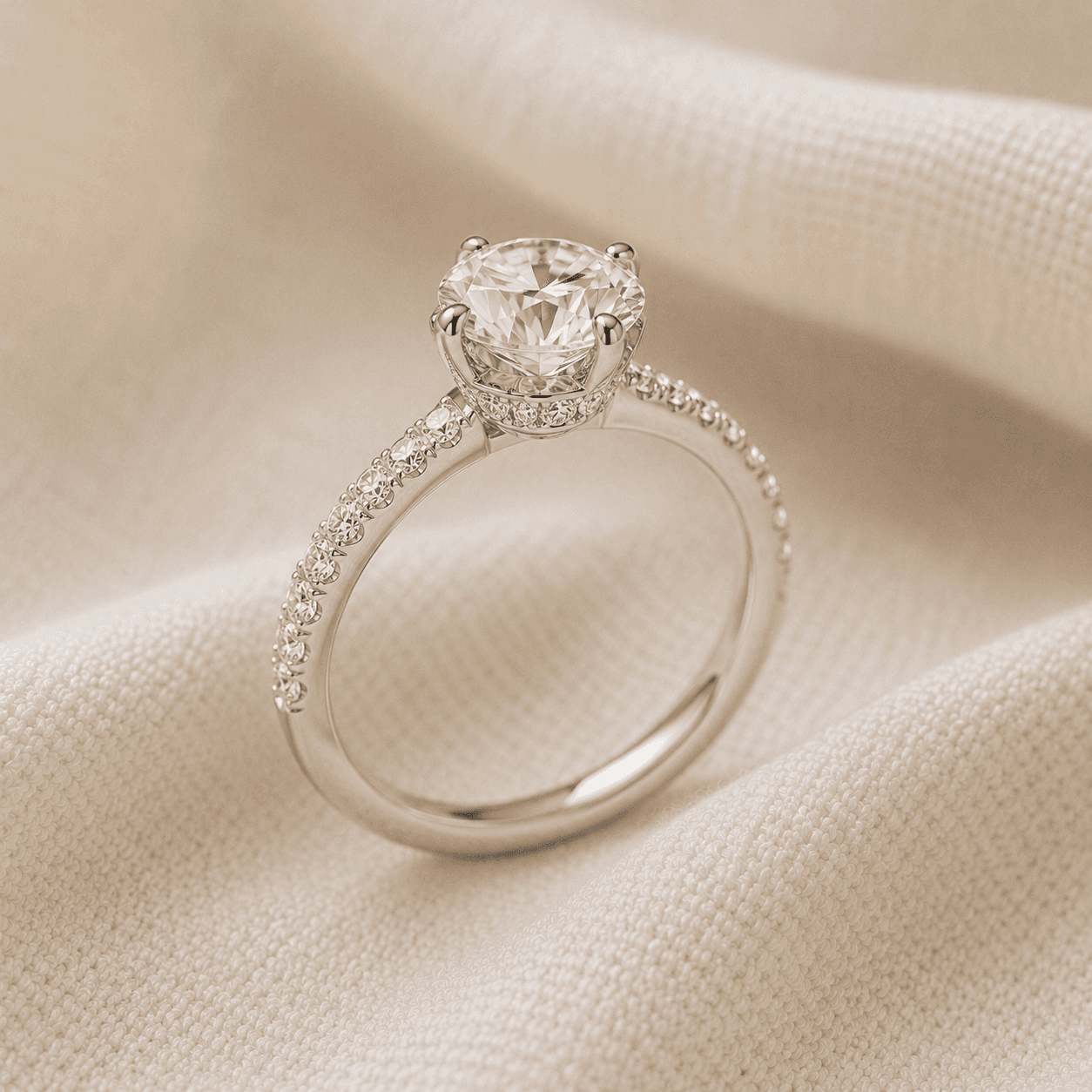 Round brilliant engagement ring with hidden halo of small diamonds