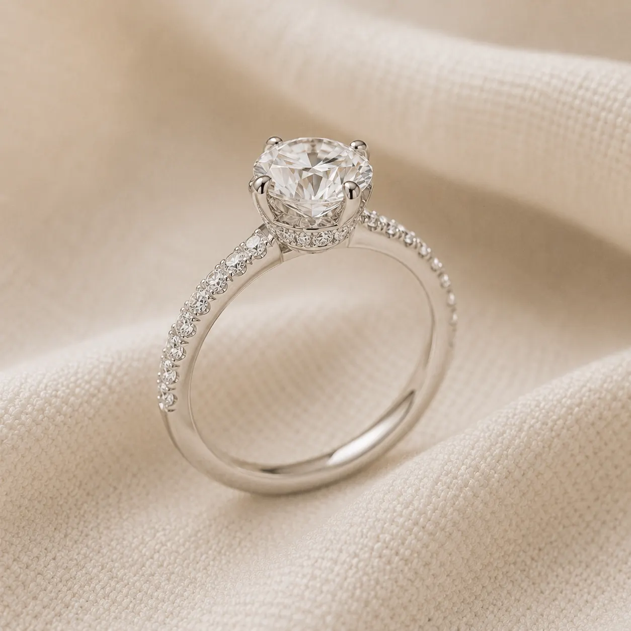 Round brilliant engagement ring with hidden halo of small diamonds