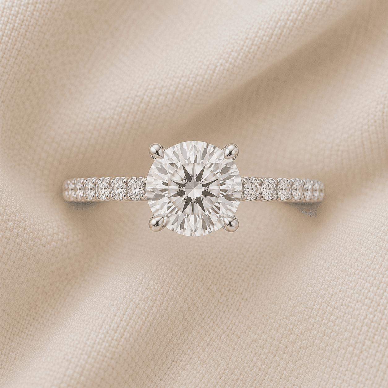 Round brilliant engagement ring with pavé diamond band
