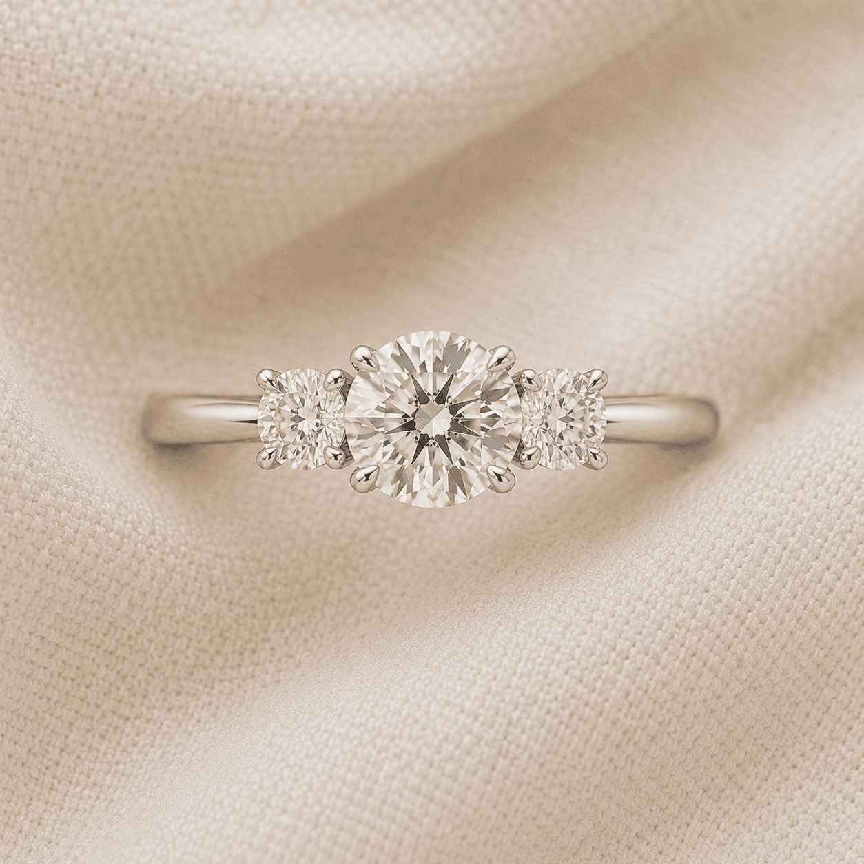 Round cut three stone engagement ring