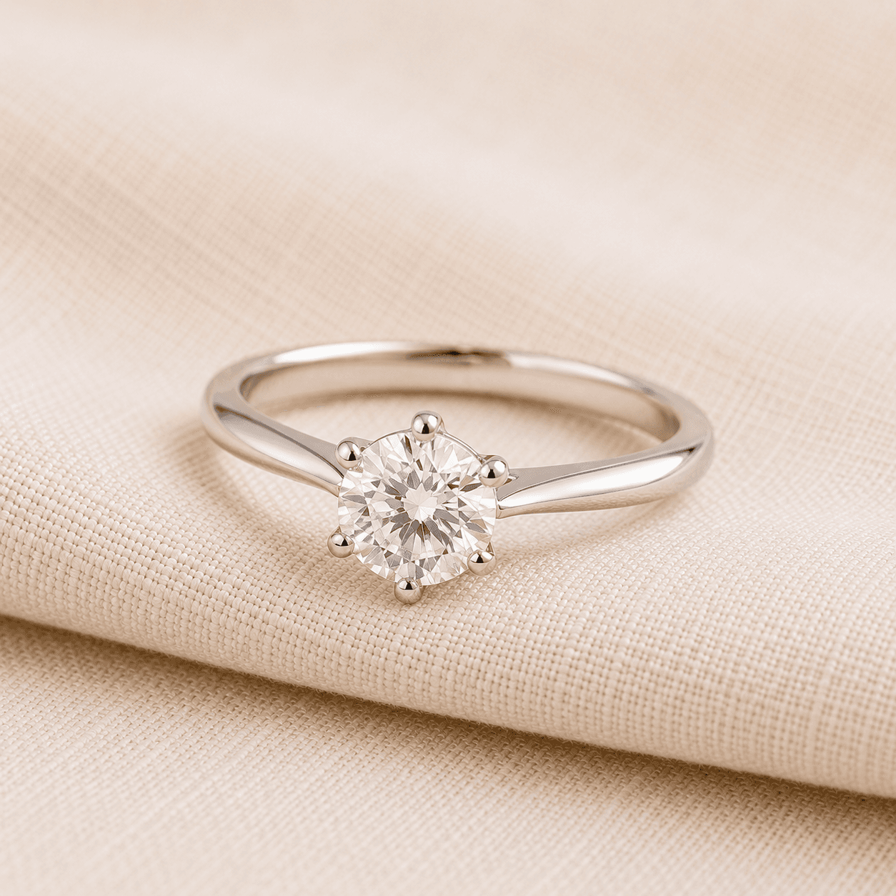 Solitaire engagement ring for women on cream linen at ATL Luxury Jewelers Atlanta