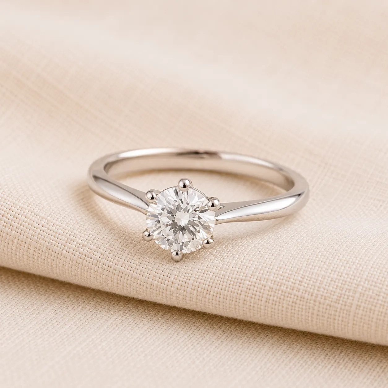 Solitaire engagement ring for women on cream linen at ATL Luxury Jewelry Atlanta