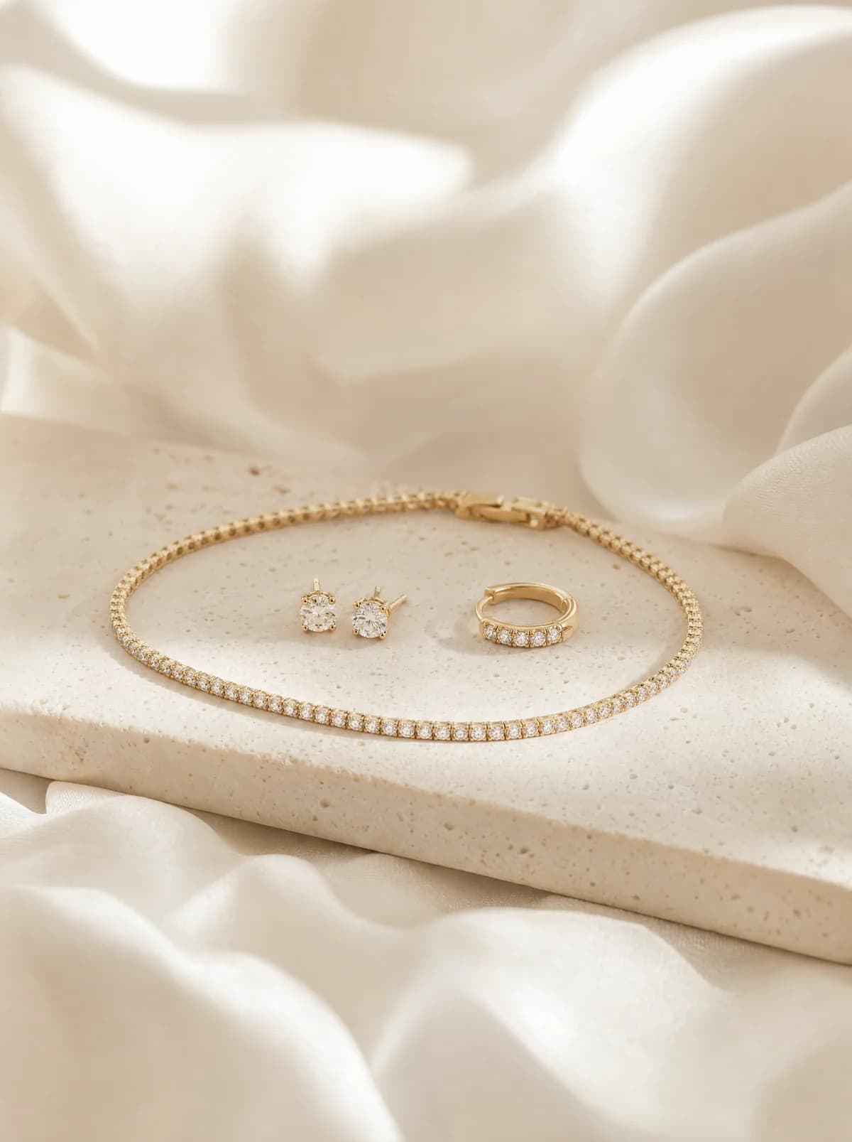 Diamond stud earrings, gold hoop and tennis bracelet