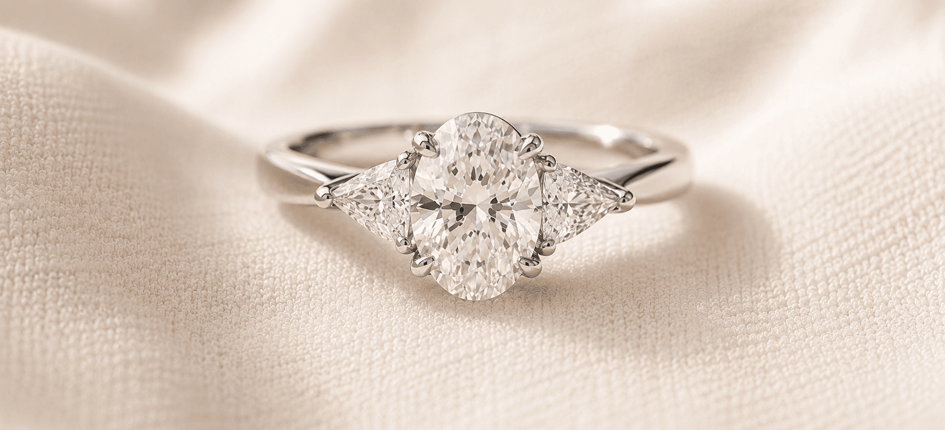 Three stone diamond engagement ring with center stone flanked by trillion side diamonds, handcrafted at ATL Luxury Jewelers in Atlanta