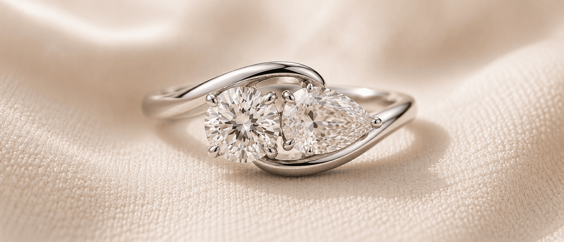 Two stone toi-et-moi engagement ring with a round and pear diamond side by side, handcrafted at ATL Luxury Jewelers in Atlanta