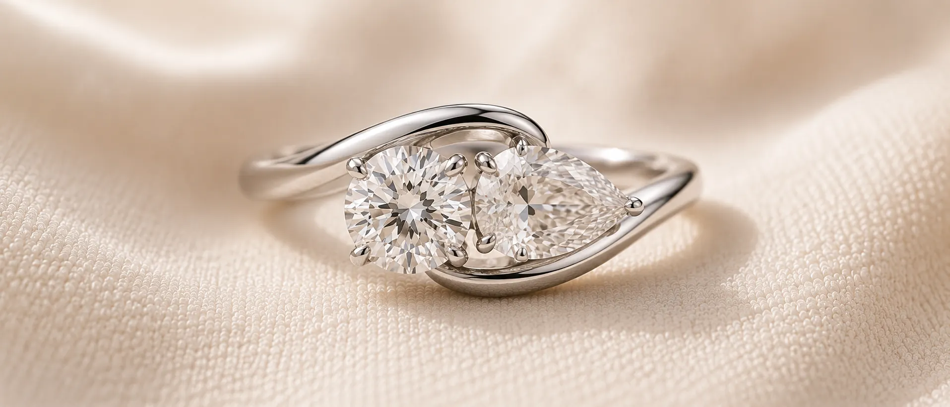 Two stone toi-et-moi engagement ring with a round and pear diamond side by side, handcrafted at ATL Luxury Jewelry in Atlanta
