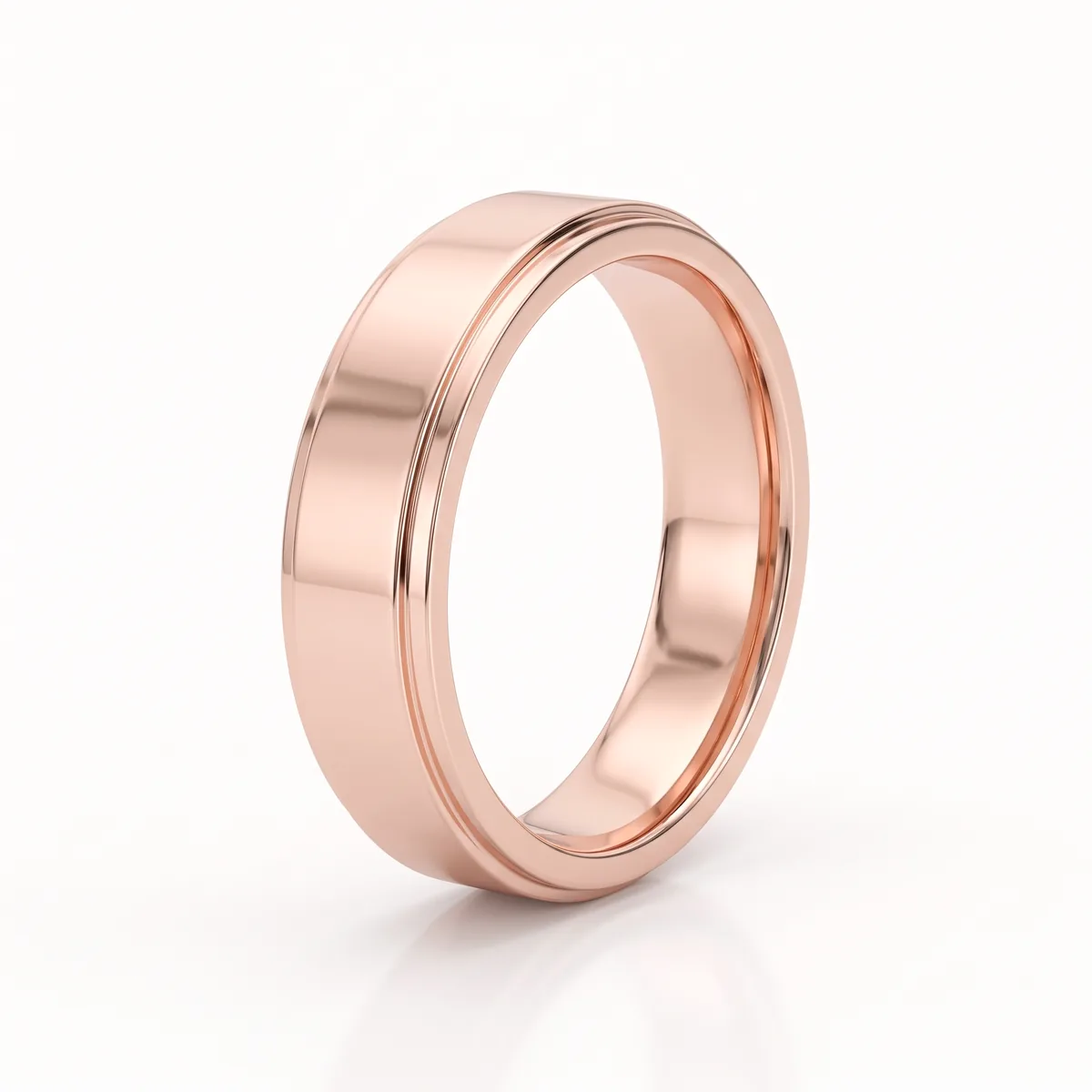 A polished rose gold wedding band with a bevelled, stepped edge, seen at a slight angle on a pale background