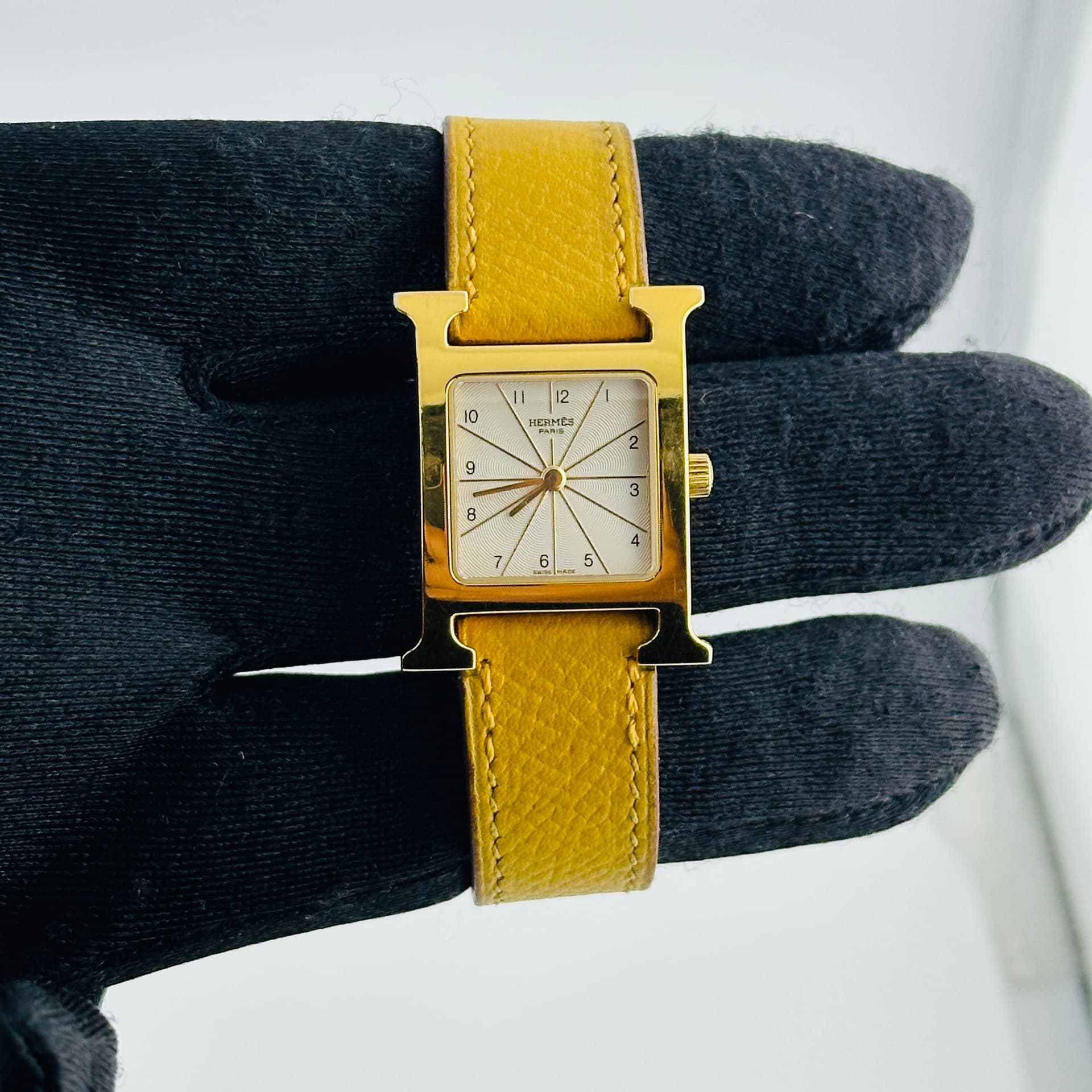 Hermes H White Dial on Leather Ref. HH1.201 — 21mm Stainless Steel & Yellow Gold Plating case, White dial, Leather bracelet. Good. Strap Color is fading..